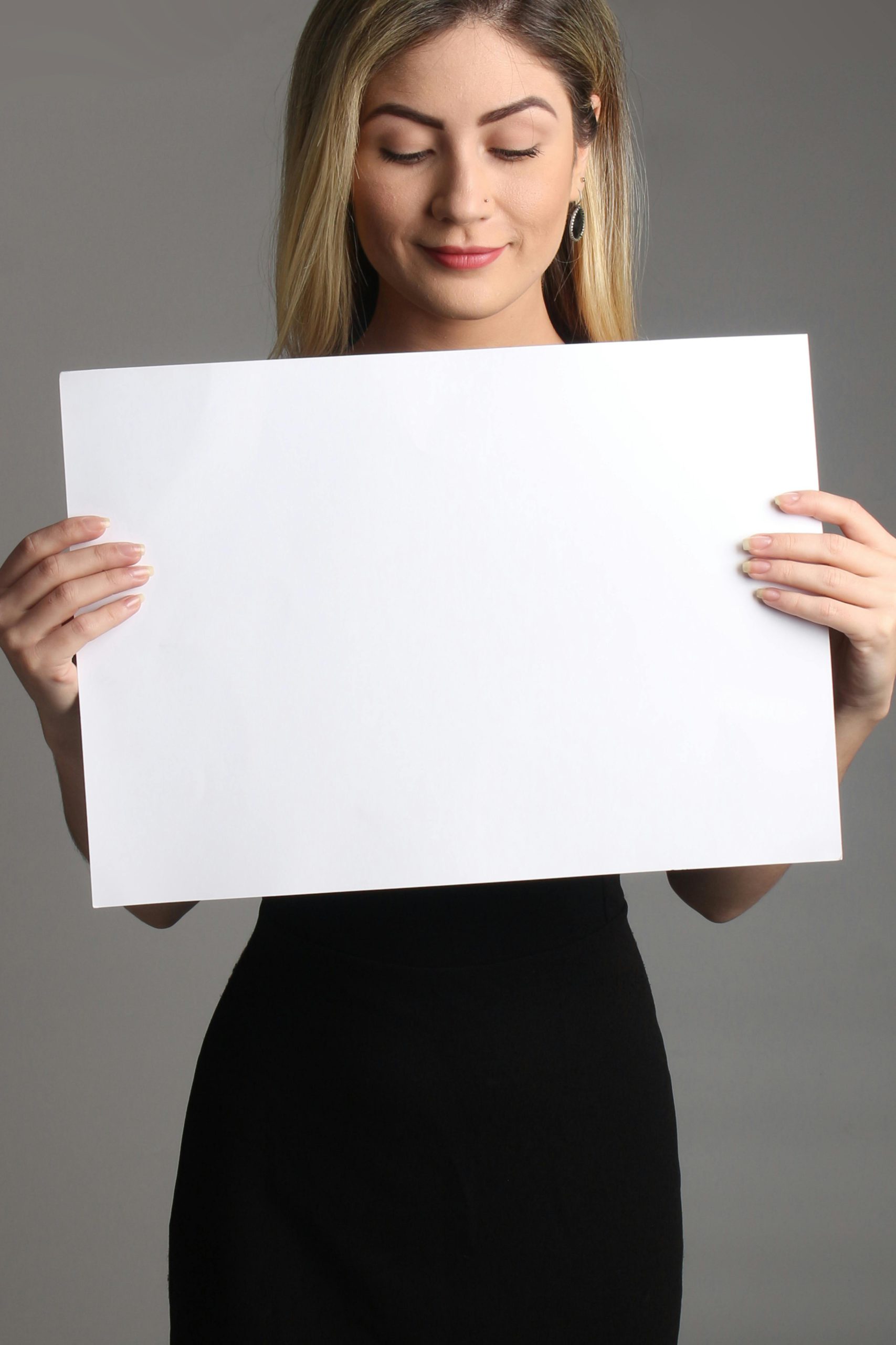 Female Homeowner Holding A Sign (1)